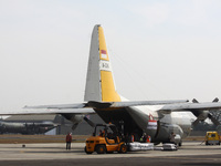 Indonesian soldiers load sacks of government food aid onto an air force C-130 aircraft, bound for Bangladesh and its cargo destined for Rohi...