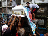 The body of slain teenager Reynaldo De Guzman is laid to rest at a cemetery during funeral rites in suburban Pasig City, east of Manila, Phi...
