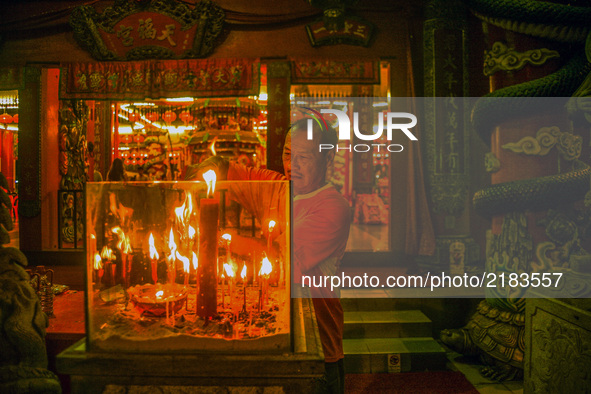 Member of chinese burn a joss sticks as he perform a specials prayer during the hungry ghost festivals in Teluk Pulai Klang, Malaysia on Sep...