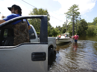Locals check in on residents remaining in the 
severe flooded area of Black Creek in Middleburg, Florida, USA,  on September 12, 2017.  (