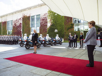 German Chancellor Angela Merkel awaits for the arrival of French Prime Minister Edouard Philippe upon his arrival at the Chancellery in Berl...