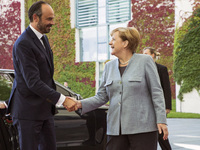 German Chancellor Angela Merkel greets French Prime Minister Edouard Philippe upon his arrival at the Chancellery in Berlin on September 15,...