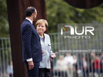 German Chancellor Angela Merkel and French Prime Minister Edouard Philippe are pictured after listening to the national anthems at the Chanc...