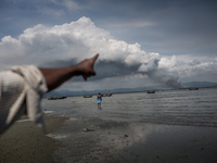 Pointing with finger, a Rohingya refugee is showing smoke on Myanmar's side of border as Myanmar military sets fire on his village. Shahpire...