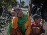 Exhausted Rohingya refugees rest on the shore after crossing the Bangladesh-Myanmar border by boat. Bangladesh will use troops to deliver fo...