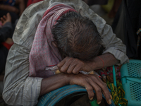 An exhausted Rohingya refugee at Shahpirer Dip, Teknaf, Bangladesh; September 14, 2017. Bangladesh will use troops to deliver foreign aid to...