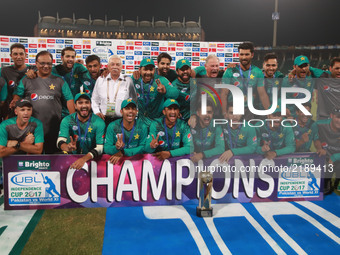 Pakistani cricketers pose for a photograph with trophy after winning the third and final Twenty20 International match against World XI at th...