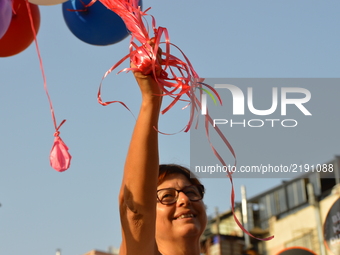 A woman holds balloons as people protest against the Turkish government's new education policies in Ankara, Turkey on September 16, 2017. Th...