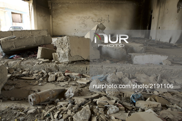 Explosive remnants of war in a bombed out IED factory in East Mosul. IS mark and writing on the wall in the back. Mosul, Iraq, on 11 Septemb...