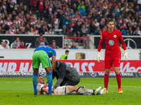 Stuttgarts Christian Gentner lies on the ground after a duel with Wolfsburgs keeper Casteels. He suffers a brain concussion and bone fractur...