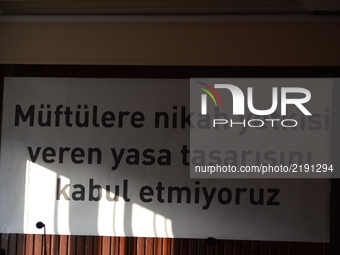 A banner reading 'We do not accept the law proposal that authorizes muftis to perform marriages' is pictured prior to women's meeting agains...