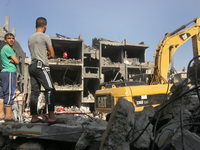 Palestinians inspects the rubbles, following Hamas says three of its senior commanders have been killed in an Israeli airstrike in Rafah in...