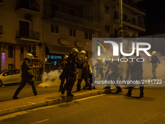 People run from tear gas fired by police after a group of protesters threw molotov cocktails during an anti-fascism demonstration in Athens...