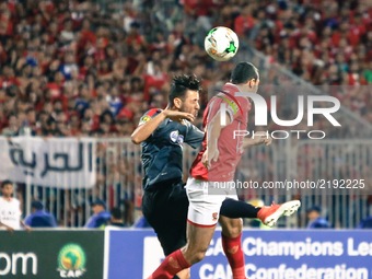 Ahly player Ramy Rabiaa ( L ) during the CAF Champions League quarterfinal first-leg football match between Egypt's Al-Ahly and Tunisia's Es...