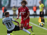 Maksim Paliyenko (L) of FC Tosno and Georgi Tigiyev of FC Spartak Moscow vie for the ball during the Russian Football League match between F...