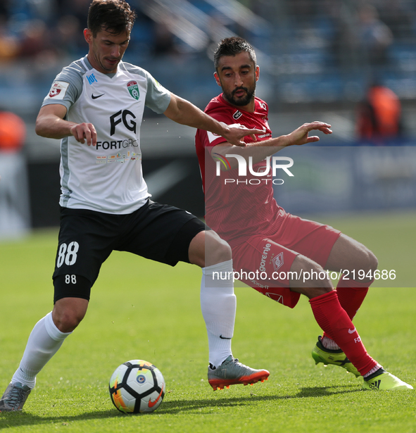 Marco Poletanovic of FC Tosno and Aleksandr Samedov (R) of FC Spartak Moscow vie for the ball during the Russian Football League match betwe...