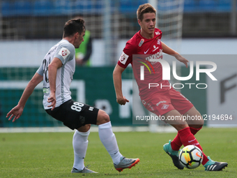 Marco Poletanovic (L) of FC Tosno and Mario Pasalic of FC Spartak Moscow vie for the ball during the Russian Football League match between F...