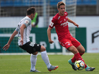 Marco Poletanovic (L) of FC Tosno and Mario Pasalic of FC Spartak Moscow vie for the ball during the Russian Football League match between F...