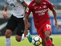 Rade Dugalic of FC Tosno and Pedro Rocha (R) of FC Spartak Moscow vie for the ball during the Russian Football League match between FC Tosno...