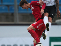 Anton Zabolotny of FC Tosno and Ilya Kutepov (L) of FC Spartak Moscow vie for the ball during the Russian Football League match between FC T...