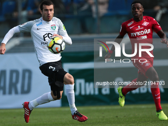 Aslan Dudiyev (L) of FC Tosno and Quincy Promes  of FC Spartak Moscow vie for the ball during the Russian Football League match between FC T...