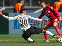 Evgeny Markov (L) of FC Tosno and Dmitri Kombarov of FC Spartak Moscow vie for the ball during the Russian Football League match between FC...