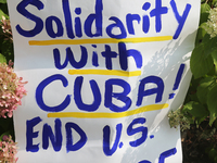 Sign saying 'solidarity with Cuba, end the U.S. blockade' during a rally to demand an end to the American blockade against Cuba (the United...