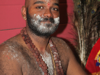 Tamil Hindu devotee covered with holy ash after ritual facial skewers were removed during the Vinayagar Ther Thiruvizha Festival in Ontario,...