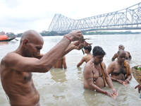 Indian  Devotees perform 'Tarpan' rituals to pay obeisance to their forefathers on the last day of 'Pitrupaksh', or days for offering prayer...