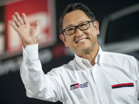 Toyota Motors president Akio Toyoda poses beside a GR86 vehicle during a press preview for the company's line of tuned road cars under the G...
