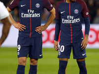 Paris Saint-Germain's Uruguayan forward Edinson Cavani (L) and Paris Saint-Germain's Brazilian forward Neymar react during the French Ligue...