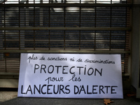A placard reading 'no more sanctions nor discriminations, protection for whistleblowers' during the hearing of Celine Boussie, French whistl...
