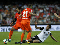 10 Dani Parejo of Valencia CF (R) in action against 14 Jose Luis Garcia del Pozo, Recio, of Malaga CF (L)     during spanish La Liga match b...