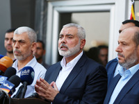 Hamas Chief Ismail Haniyeh speaks to the press upon his arrival on the Palestinian side of the Rafah border crossing, in the southern Gaza S...