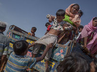 A Rohingya refugee kid is being pulled down from a truck that carried the refuges from the border to Balukhali refugee camps.  Cox’s Bazar,...