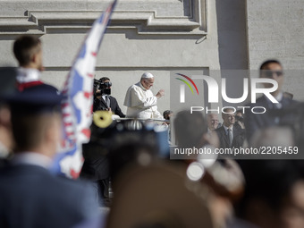 Pope Francis greets the faithful as he arrives to celebrate his Weekly General Audience in St. Peter's Square in Vatican City, Vatican on Se...