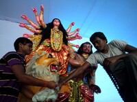 Indian artists busy to give finishing touches to the idol of goddess Durga at a worship venue ahead of the five days long Durga Puja festiva...