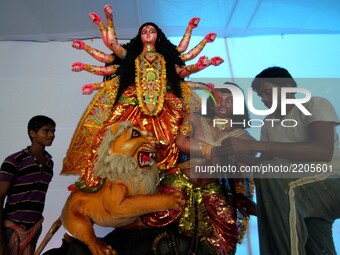 Indian artists busy to give finishing touches to the idol of goddess Durga at a worship venue ahead of the five days long Durga Puja festiva...