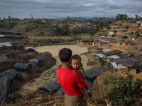 A man looks at the refugee camp standing on the top with his son at Balukhali refugee camp, Cox’s Bazar, Chittagong, Bangladesh. September 1...