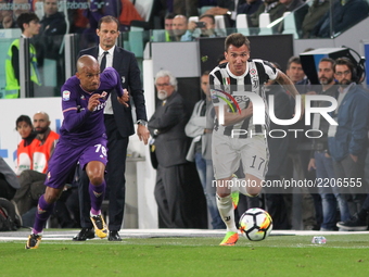 Bruno Gaspar (L, Fiorentina) and Mario Mandzukic (R, Juventus) during the Serie A football match between Juventus FC and ACF Fiorentina at A...