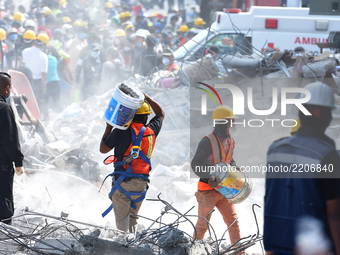 Voluntaries, soldiers and members of civil protection are seen continuing his humanitarian work to wait rescue a life during the catastrophe...
