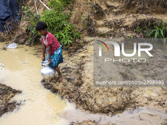 Balukhali camp resident collects drinking water from mud and clay as the supply of drinking water is inadequate. They dug a 3 to 4 feet circ...