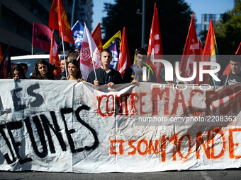 Youths hold a banner reading 'Youths against Macron and his world' during a demonstration in Toulouse against the new Macron's reforms on th...