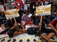 Activists hold placards during a rally commemorating the 45th anniversary of the declaration of Martial Law in Manila, Philippines, 21 Septe...