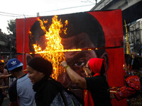 A cubic effigy painted with the face of President Rodrigo Duterte is set on fire by activists during a rally commemorating the 45th annivers...