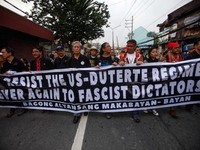 Activists march towards a park to assemble for a rally commemorating the 45th anniversary of the declaration of Martial Law in Manila, Phili...