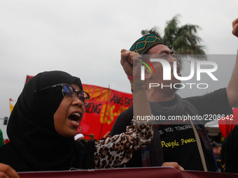 Muslim activists gesture as they chant slogans during a rally commemorating the 45th anniversary of the declaration of Martial Law in Manila...