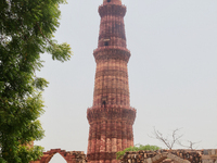 Qutub Minar tower in Delhi, India. Qutub Minar is a 73-metre (240 feet) tall tower that was built along with the Quwwat-ul-Islam Mosque arou...