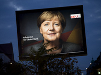 An election poster of German Chancellor Angela Merkel (CDU) are pictured in the district of Friedrichshain in Berlin, Germany on September...