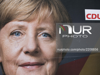 A vandalized election poster showing German Chancellor Angela Merkel (CDU) with a tear is seen in the district of Friedrichshain in Berlin,...